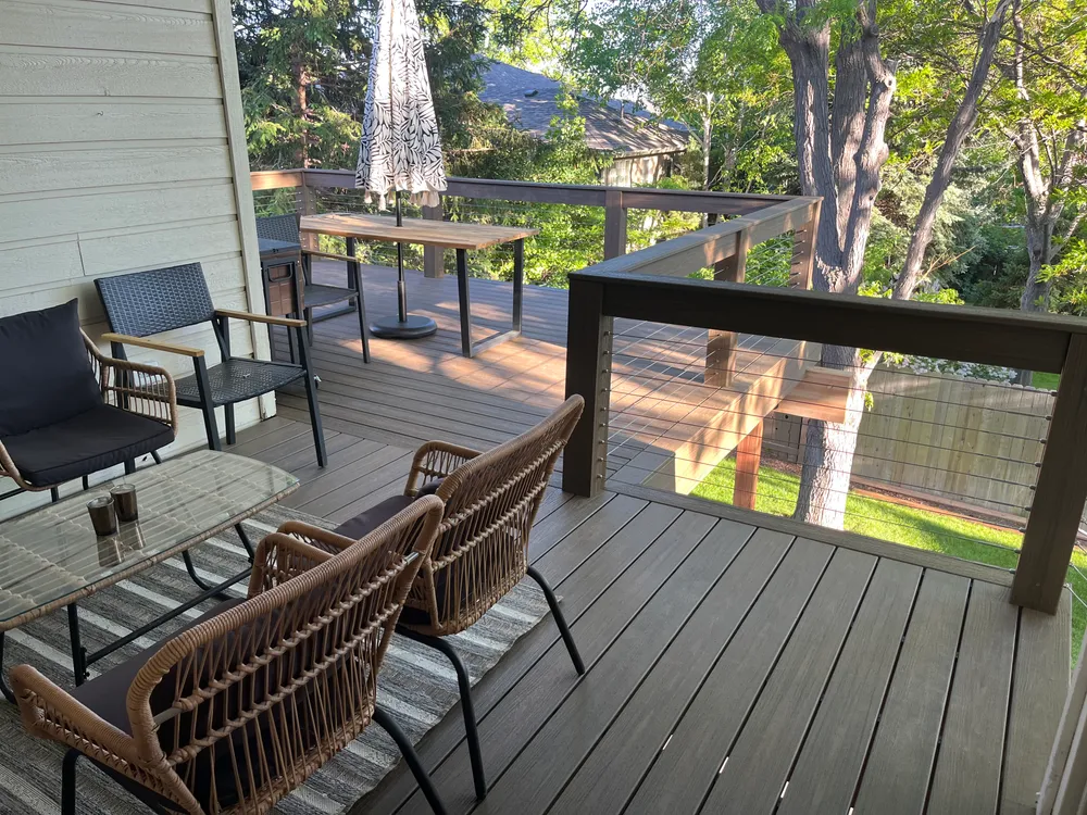 Finished composite deck with railing and patio furniture