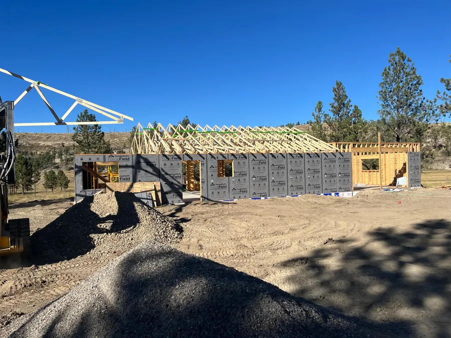 Roof trusses being set on the framed walls