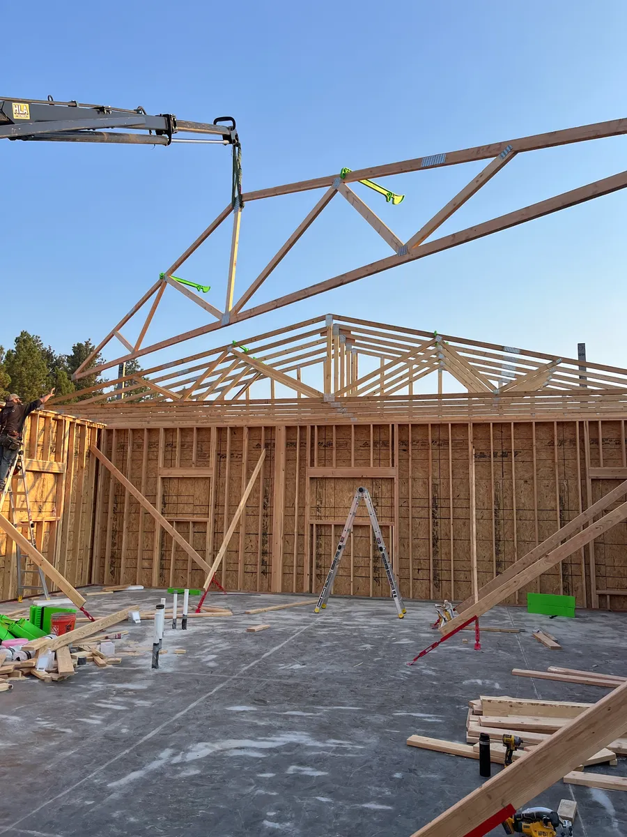 Shop walls framed with trusses being set