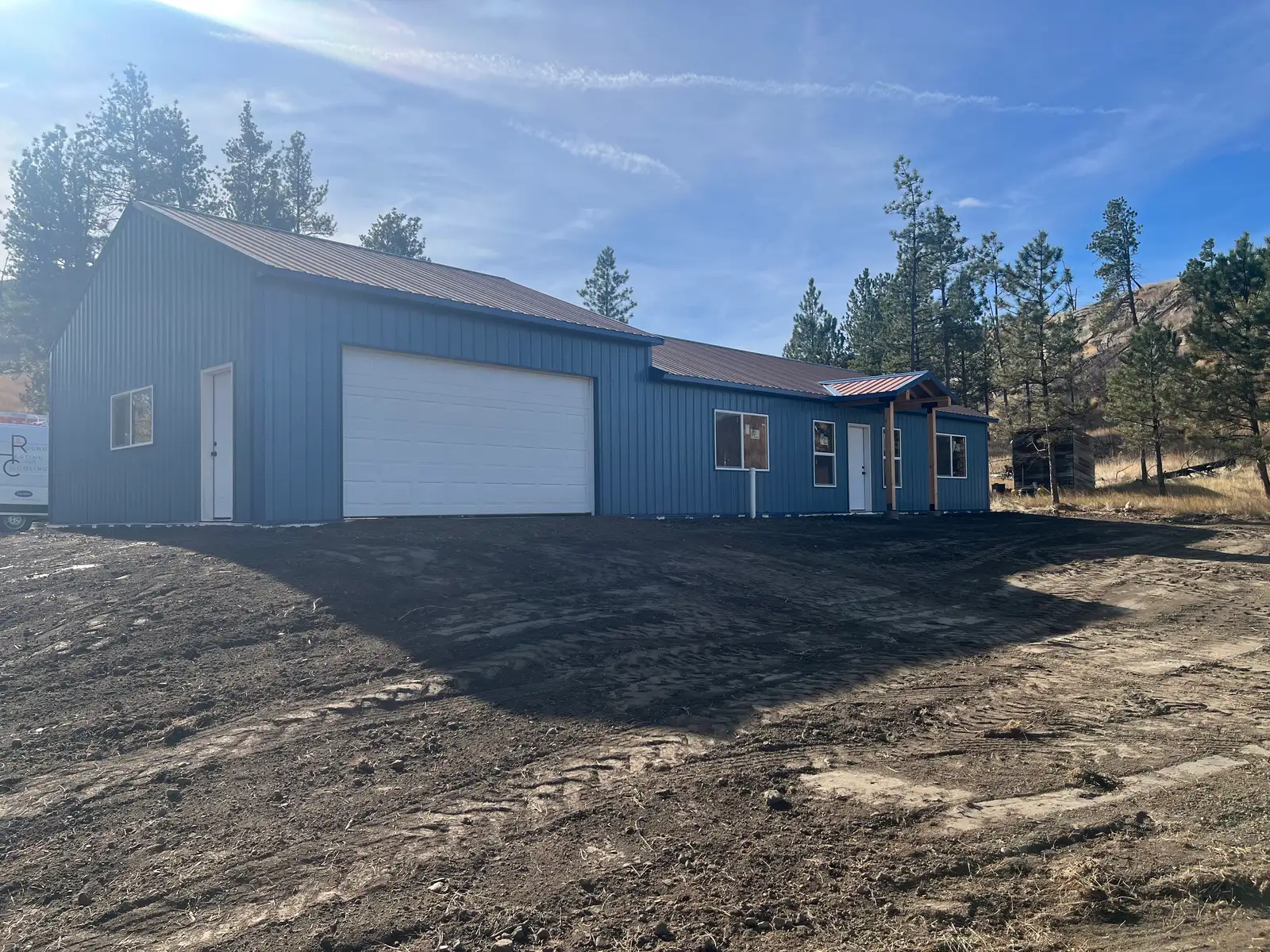 Blue custom home with an attached garage built by Hammer Down Construction