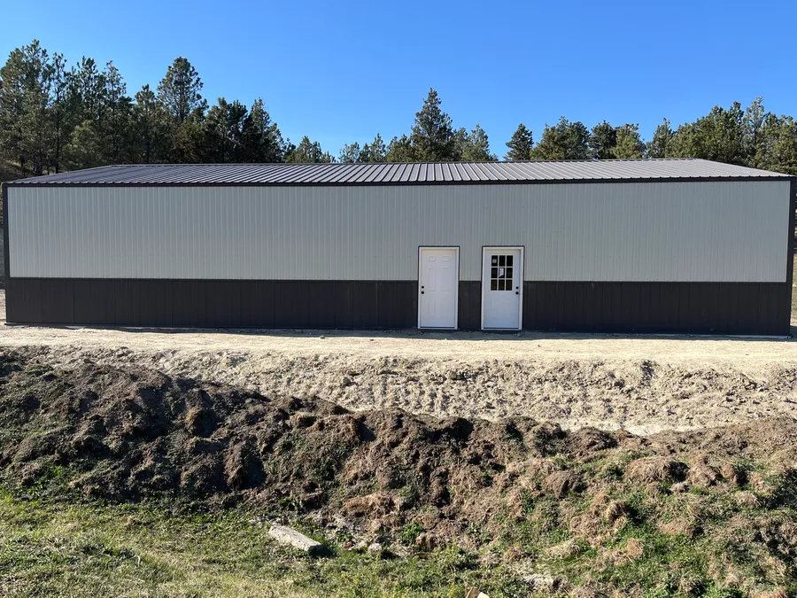 Two-tone metal siding on a finished shop building