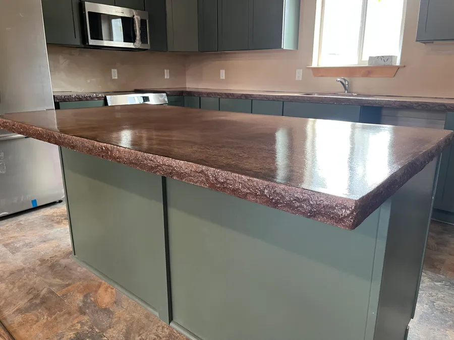 Custom concrete countertop on a kitchen island installed by Hammer Down Construction