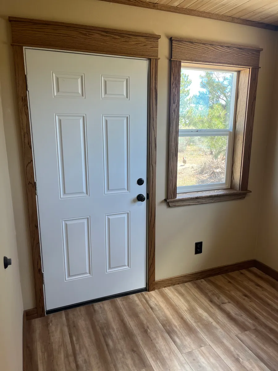 New interior door and wood trim installed during a remodel